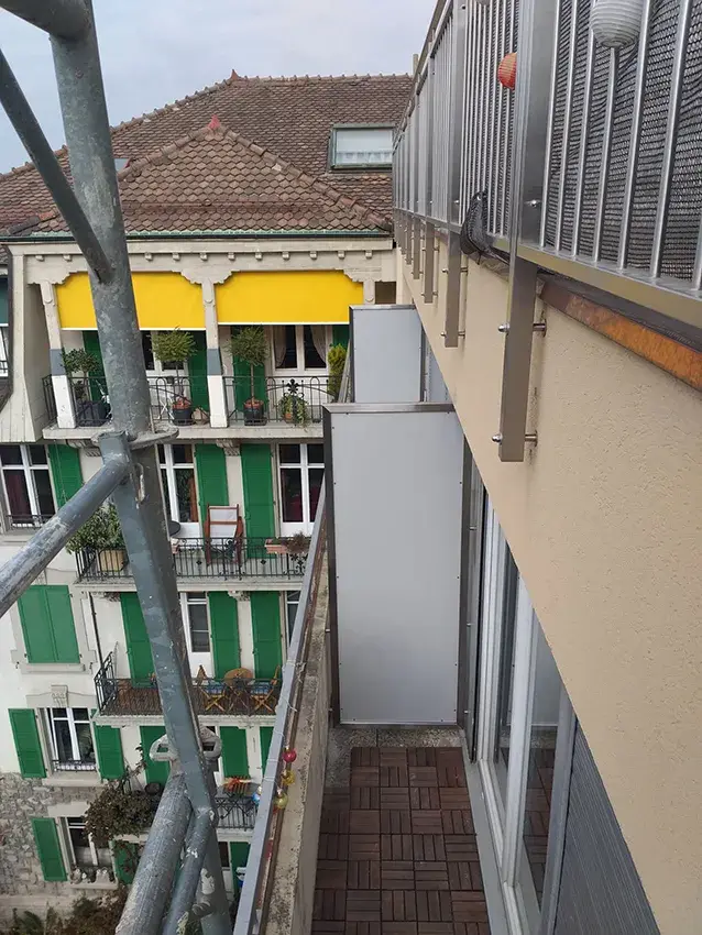 Paroi pare-vue à cadre métallique en façade d'un immeuble