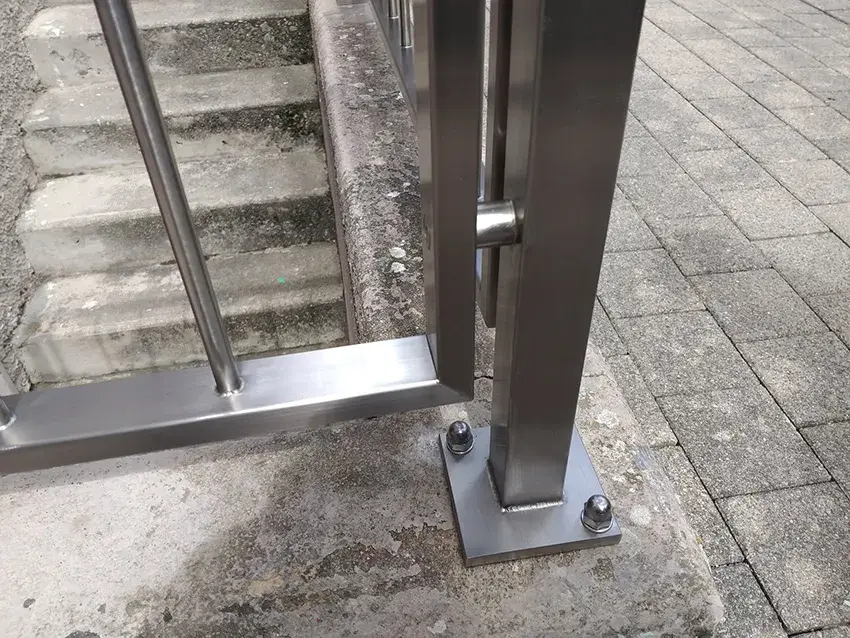 Détail du pied de poteau et des barreaux d'un garde-corps en inox