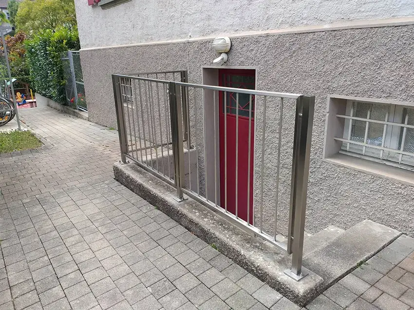 Barrière en inox à barreaux devant une entrée de sous-sol